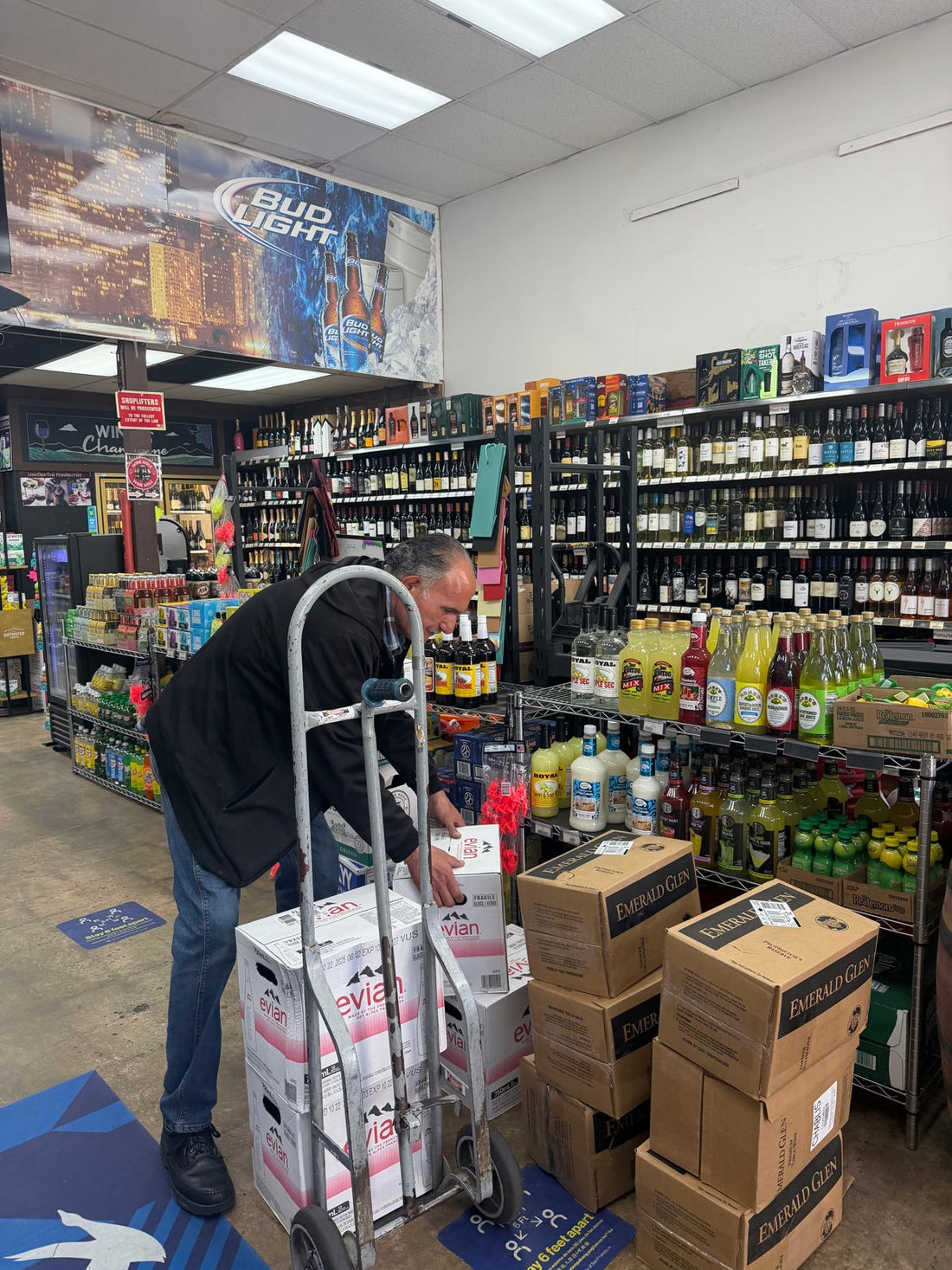 Staff stocking beverages at Mike's Beverages and Liquors, 5084 Mission St, San Francisco