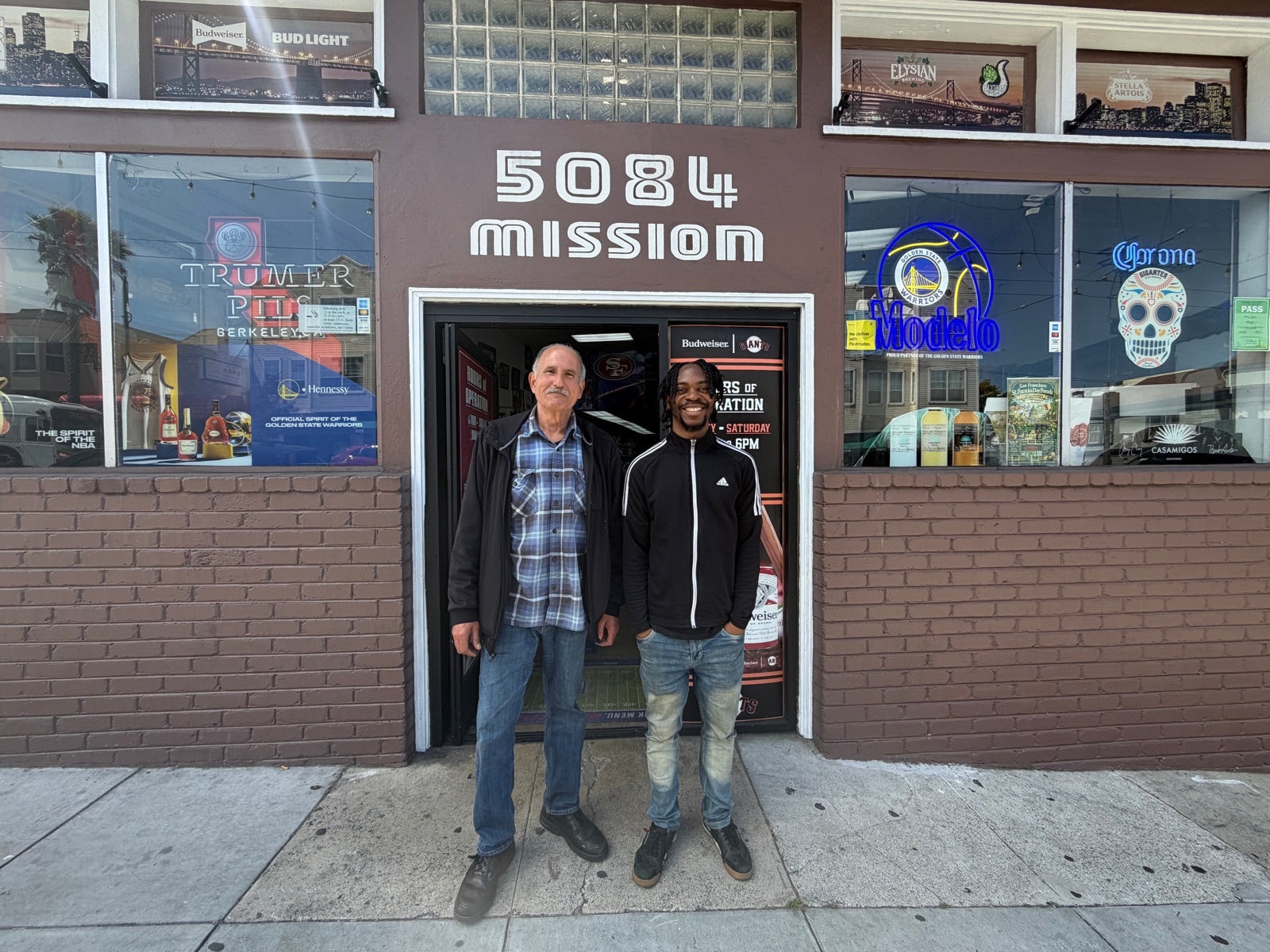 The Mike's Beverages & Liquors storefront at 5084 Mission Street in San Francisco, with staff out front