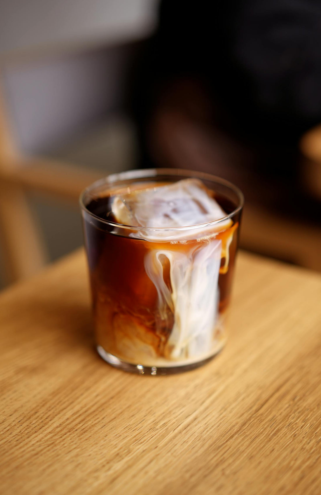 A glass of nitro cold brew coffee showing a creamy cascading pour