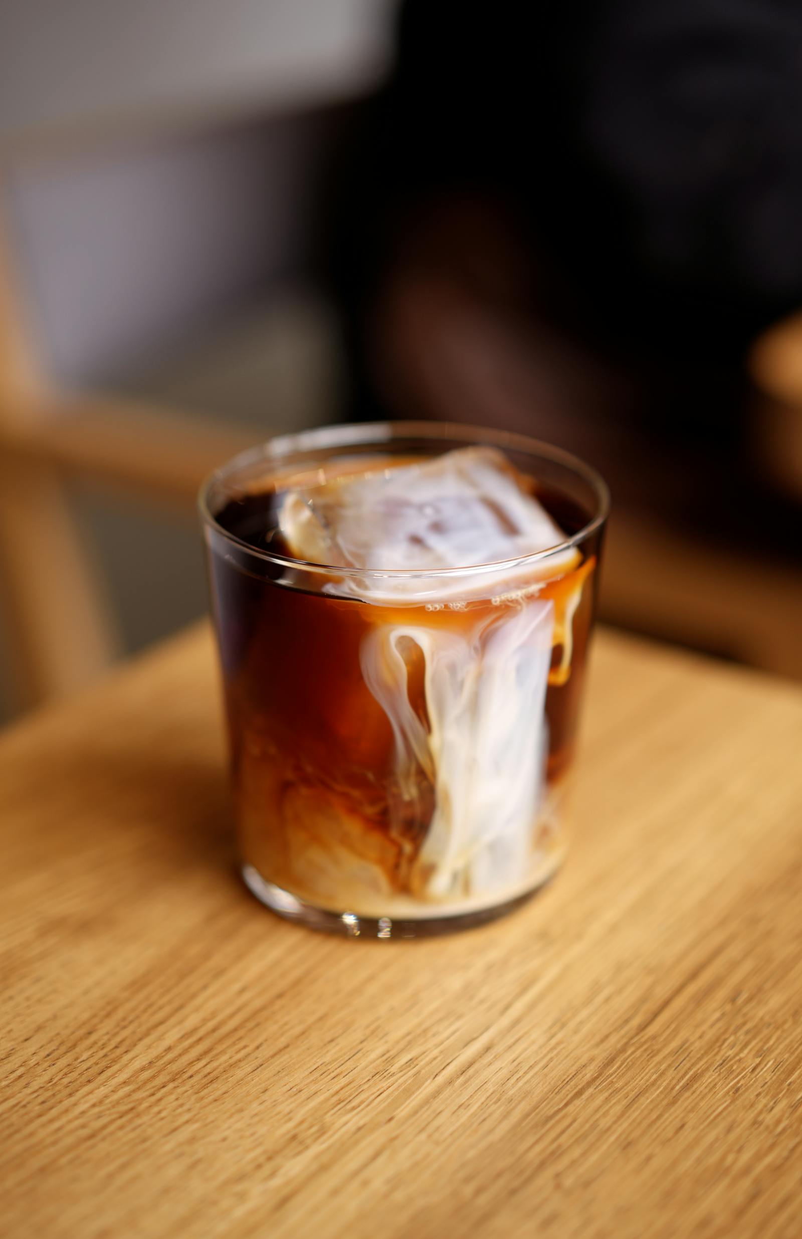 A glass of nitro cold brew coffee showing a creamy cascading pour
