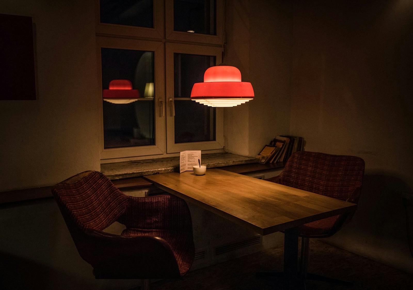Dimly lit historic bar interior with warm lighting, bottles lining the shelves