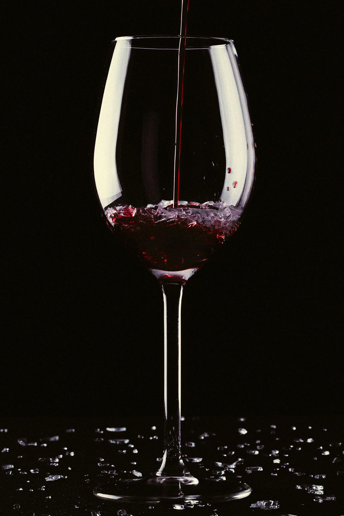 A glass of red wine being poured, illustrating wine served fresh from a keg on tap