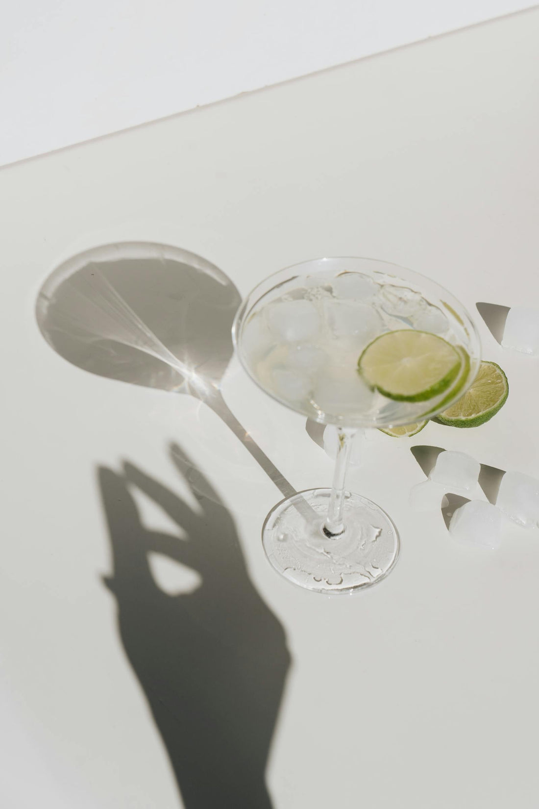 Cocktails and a beer lined up on a bar for a party
