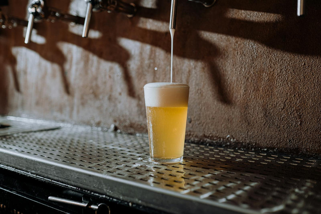 Draft beer being poured from a tap into a glass